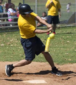 adult-male-batter swings at a pitch